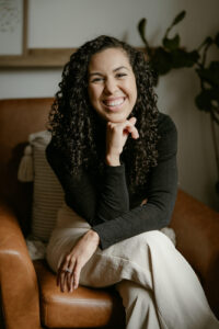 Woman wearing corporate clothing smiling at the camera